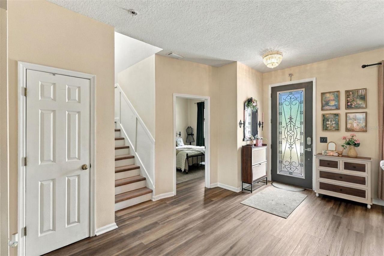 Photo 18 of 20: Front door afar, bonus room center, stairwell to 2nd floor left.