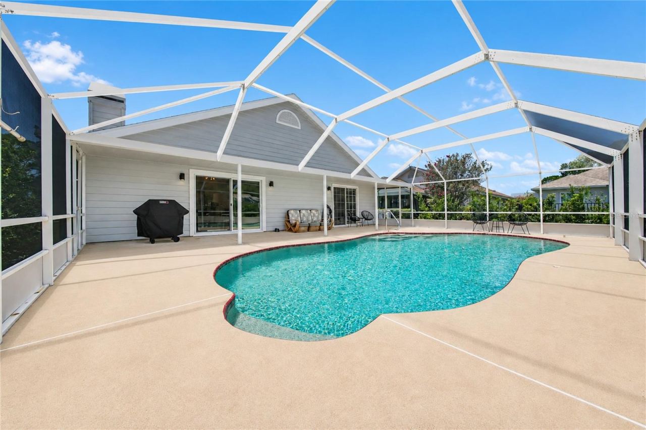 Photo 11 of 20: Enjoy the in-ground pool, spacious surrounding deck, and the 40-by-8-foot covered porch—perfect for relaxing and entertaining outdoors.
