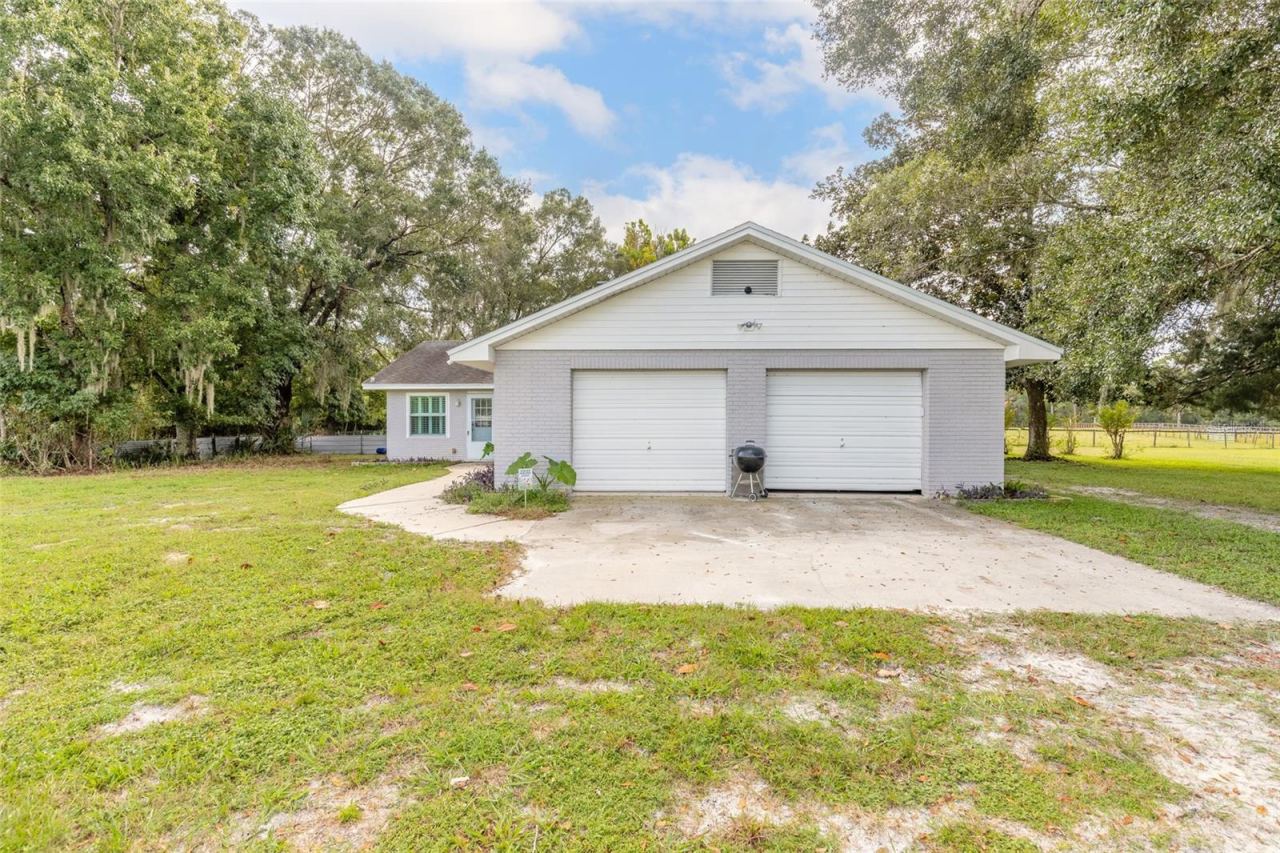 Photo 9 of 20: Side of home with garage. Garages faces back of lot.