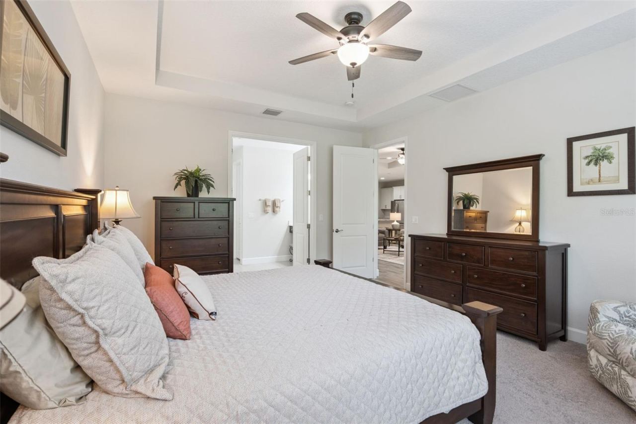 Photo 19 of 20: Alternate photo of the primary bedroom with coffered ceiling and fan