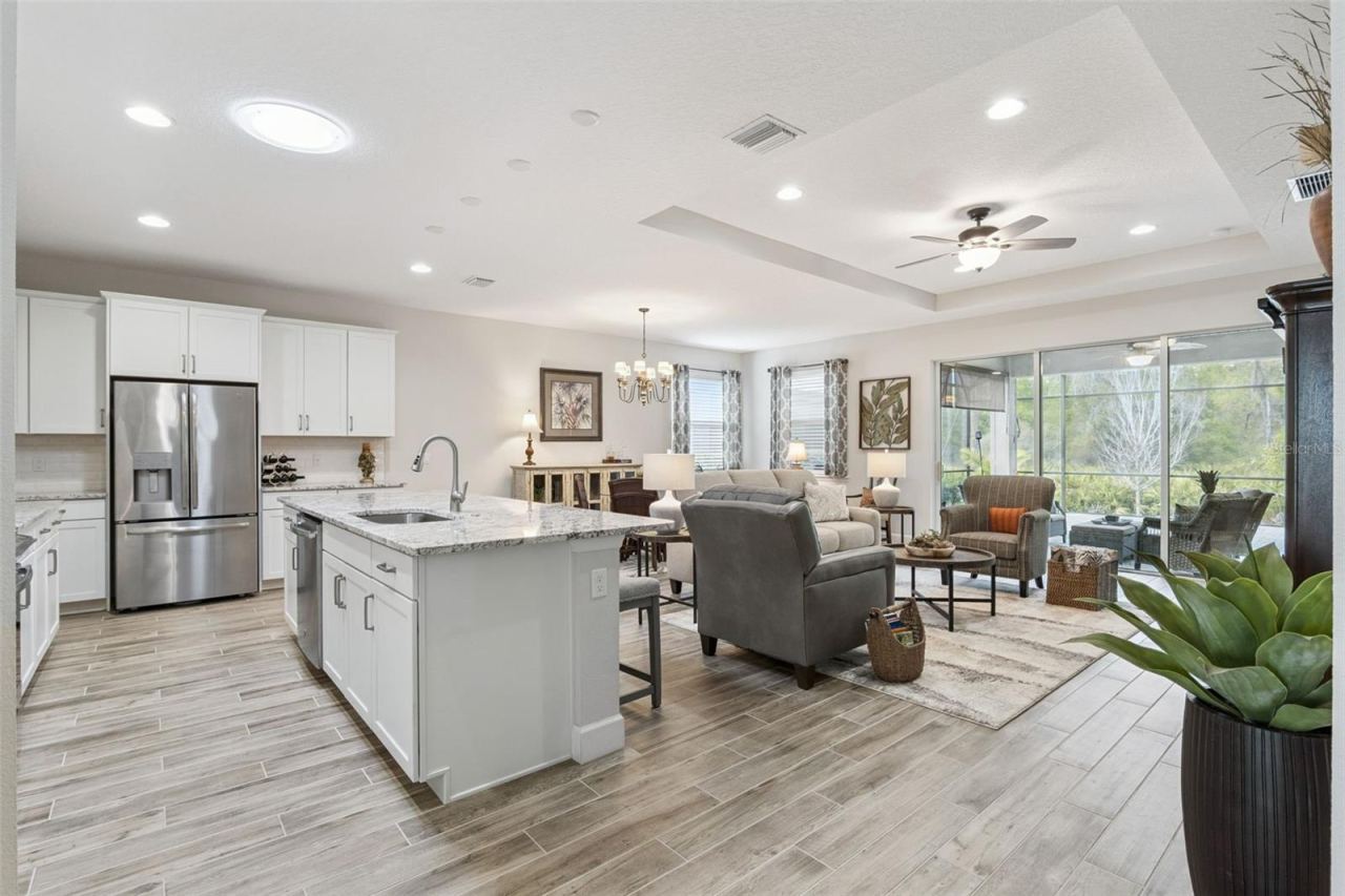 Photo 3 of 20: Easy care, wood-look plank tile runs throughout your living areas