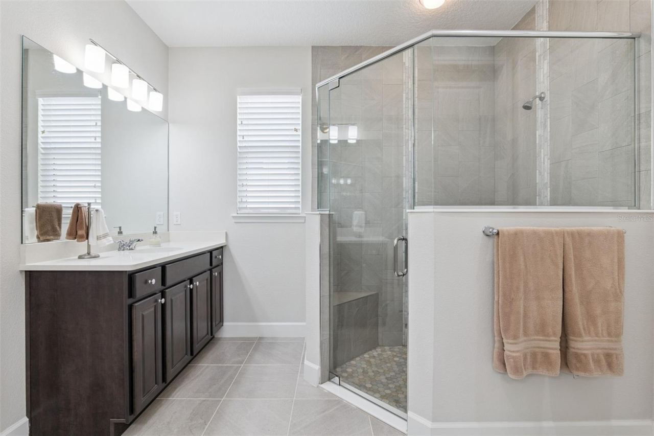 Photo 20 of 20: Primary bathroom with large shower with bench and designer tile