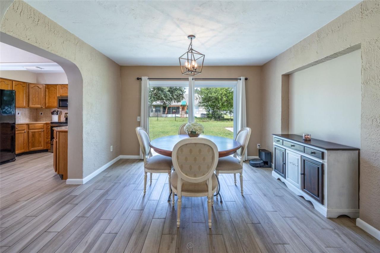 Photo 5 of 18: Dining Room with sliding glass doors to back yard