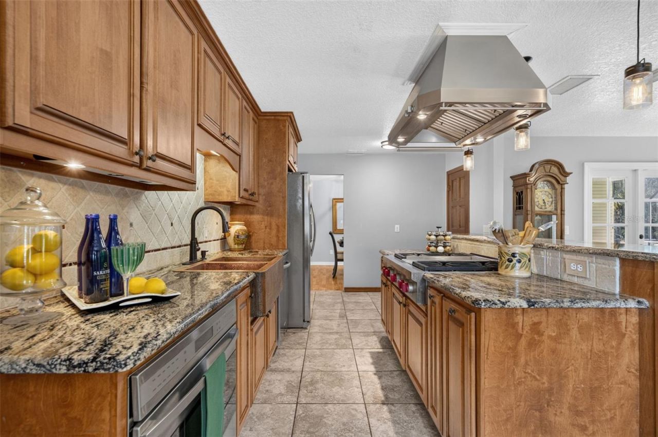Photo 15 of 20: Professional grade Range Hood over the Wolf Gas Range.