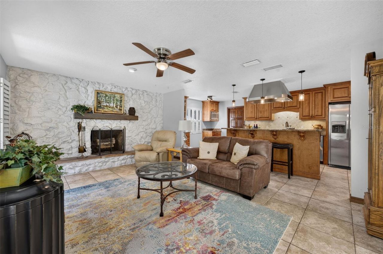 Photo 5 of 20: Open Family room Kitchen. Direct access to the screened pool.