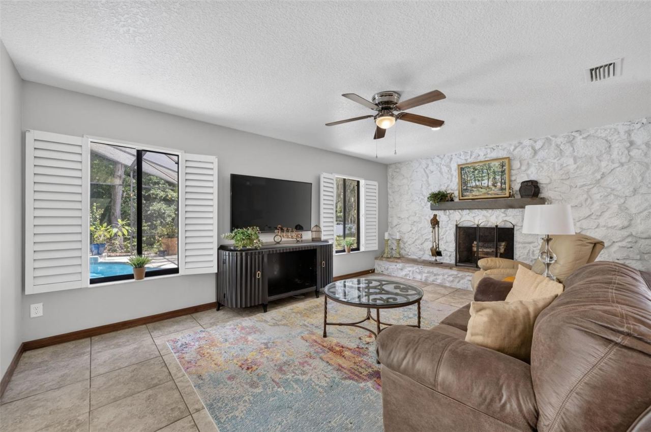Photo 8 of 20: Wood Burning Fireplace. Tile flooring and direct access to the Pool