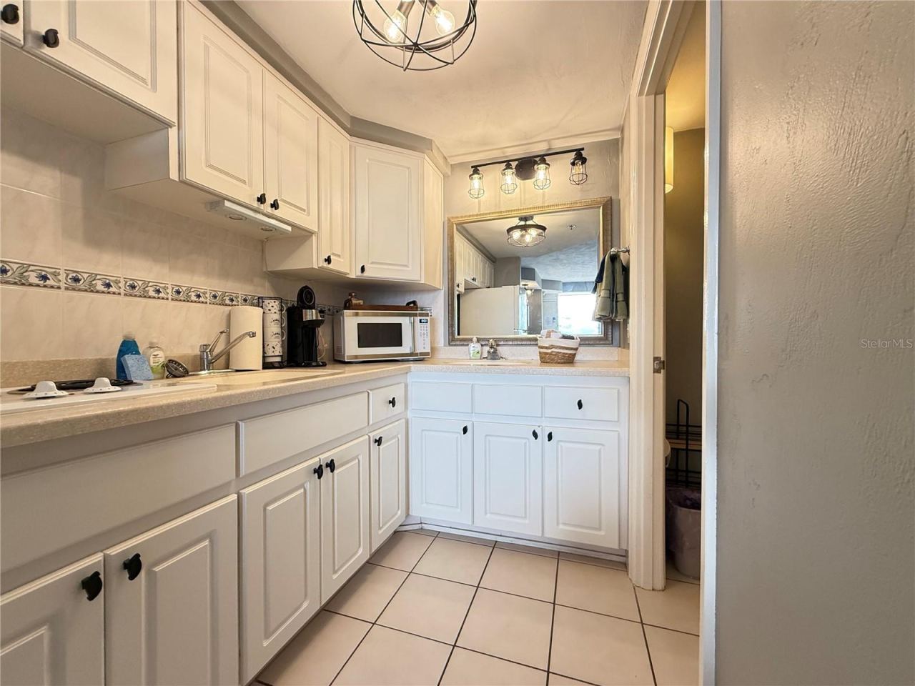 Photo 10 of 18: Kitchenette with stove top, microwave and a full size refrigerator.