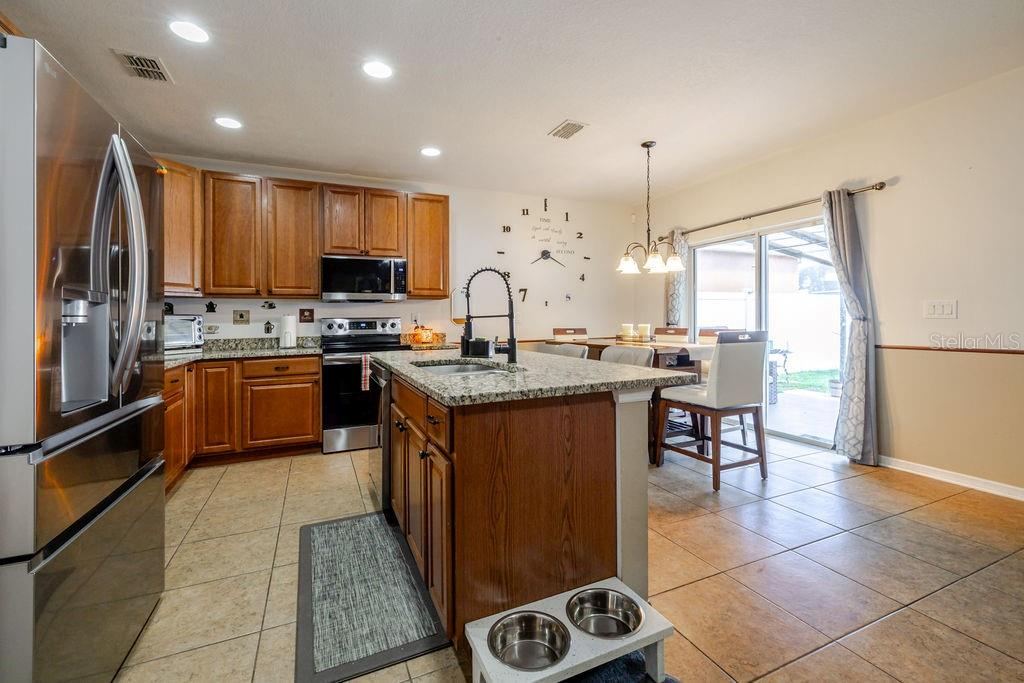 Photo 13 of 20: Kitchen and dining area with sliding glass doors to covered back patio