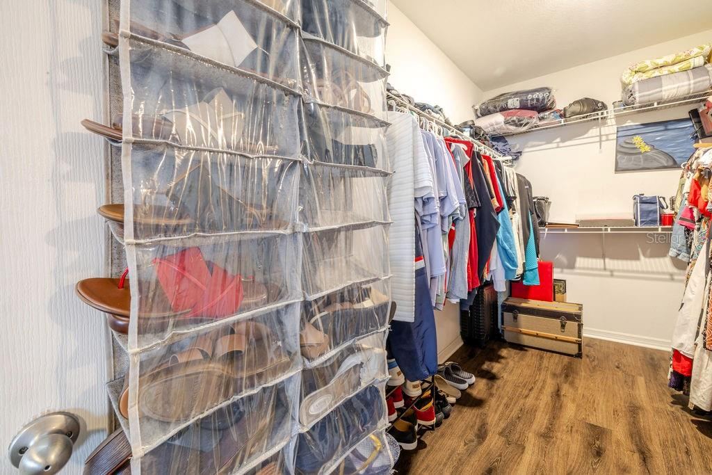 Photo 19 of 20: Oversized walk-in closet in primary bedroom