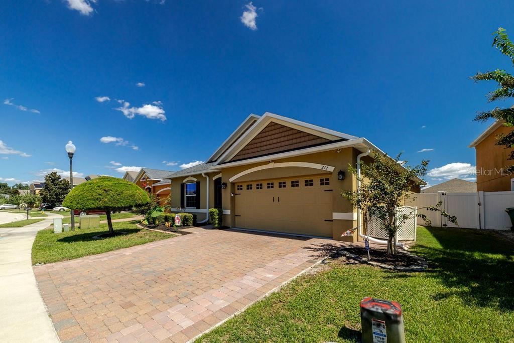 Photo 2 of 20: Side view of home with oversized paver driveway