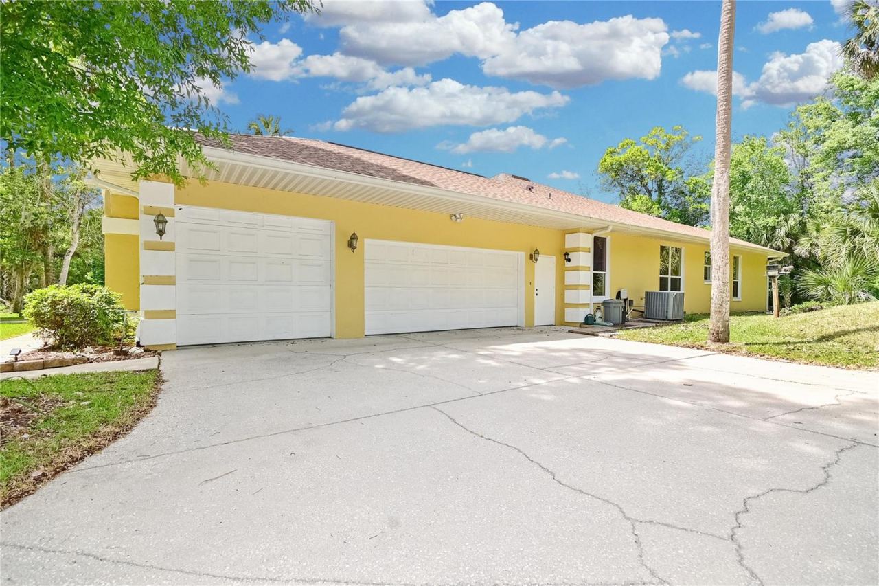 Photo 10 of 20: Home has attached 3-car garage.