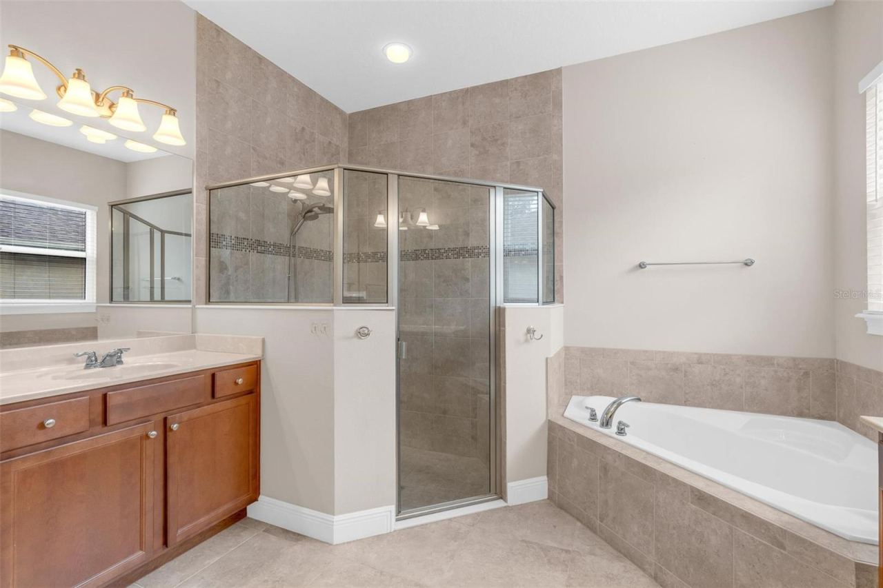 Photo 16 of 20: PRIMARY BATHROOM. DUAL SINKS, SOAKING TUB + WALK IN SHOWER