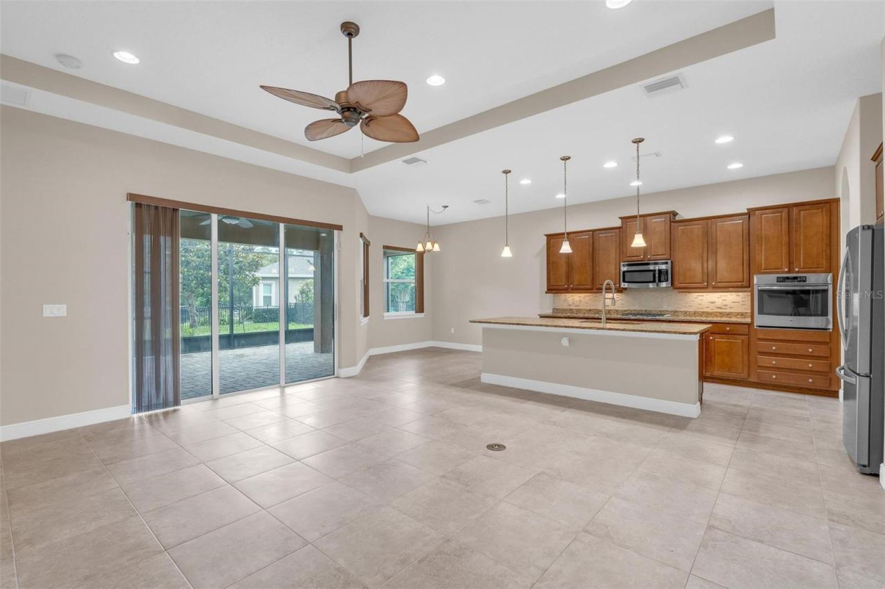 Photo 10 of 20: LIVING/DINING KITCHEN WITH SLIDERS TO SCREENED PATIO