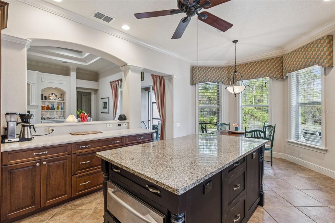 Photo 15 of 20: View of the kitchen island w/ sliding drawers & Dinette area