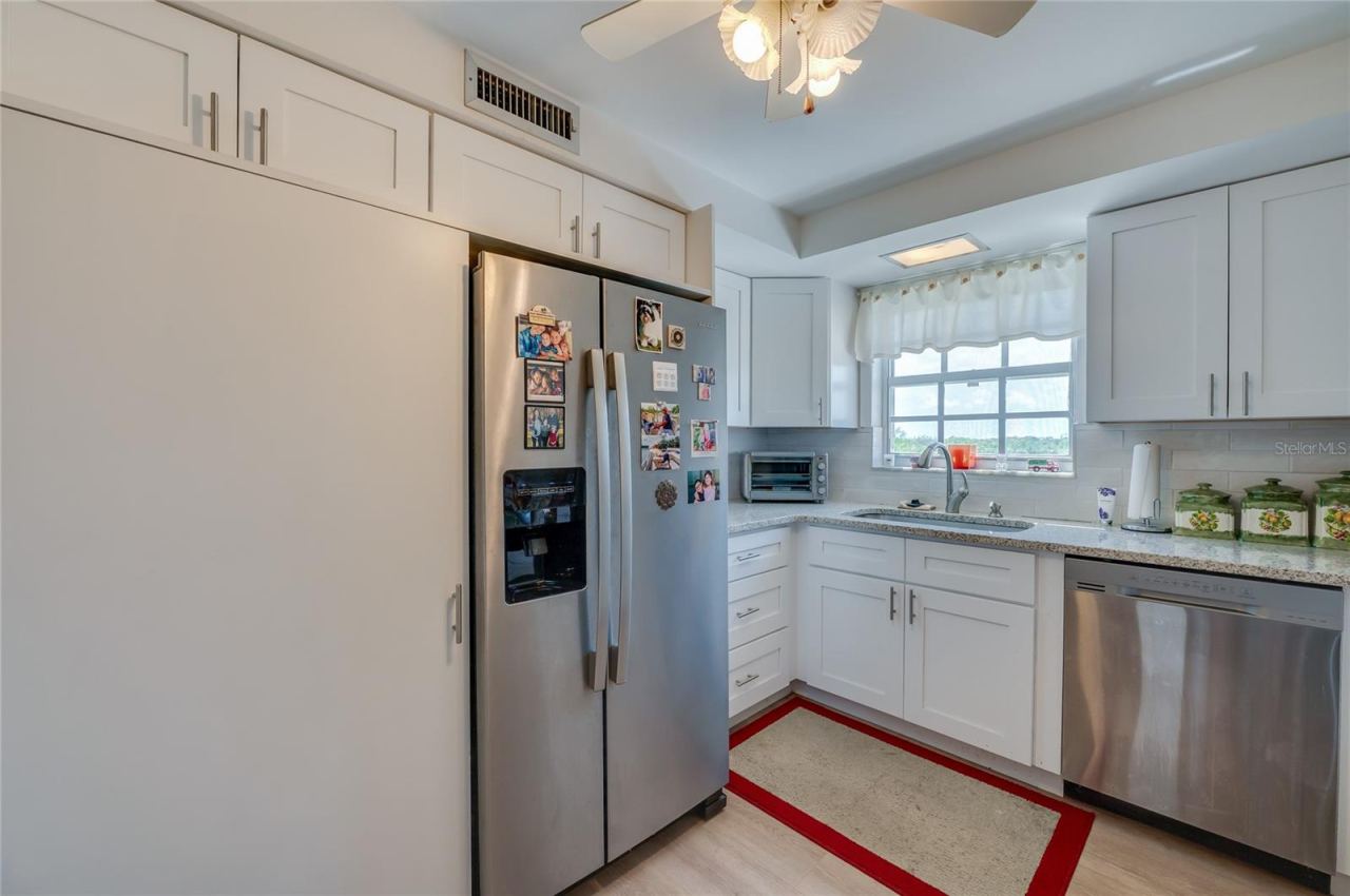 Photo 10 of 20: Full-size stack washer/dryer to left of refrigerator