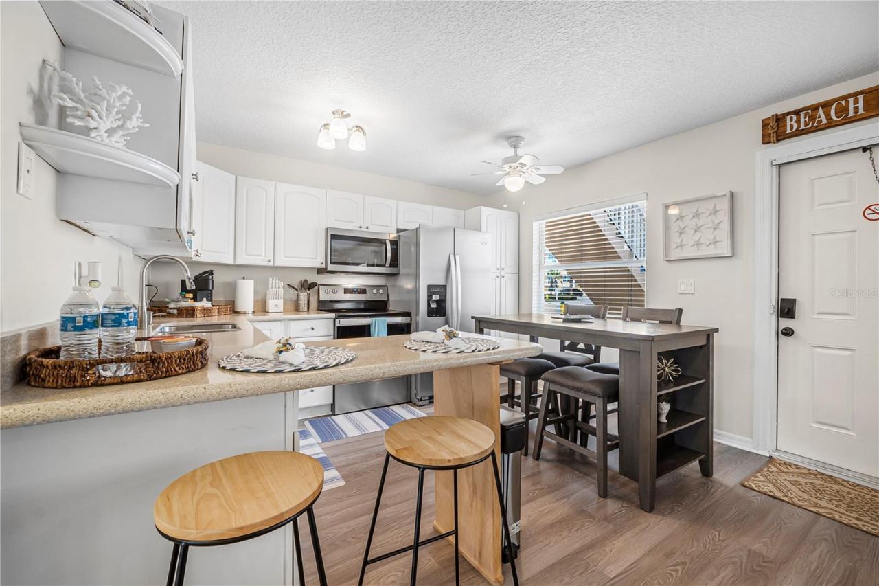 Photo 9 of 20: View from Living Room to Kitchen and Dining Area