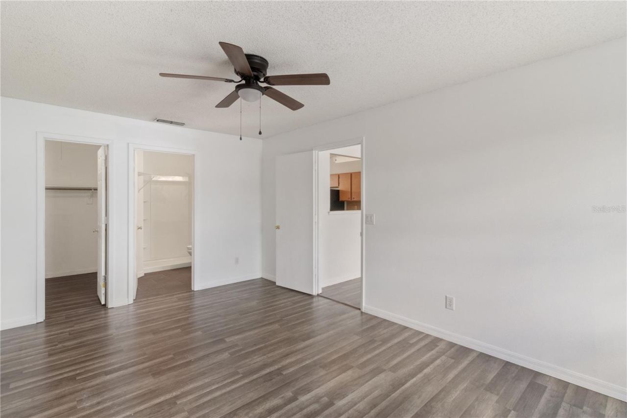 Photo 5 of 20: Primary Bedroom with View To Living Room, Bath, and Master Closet
